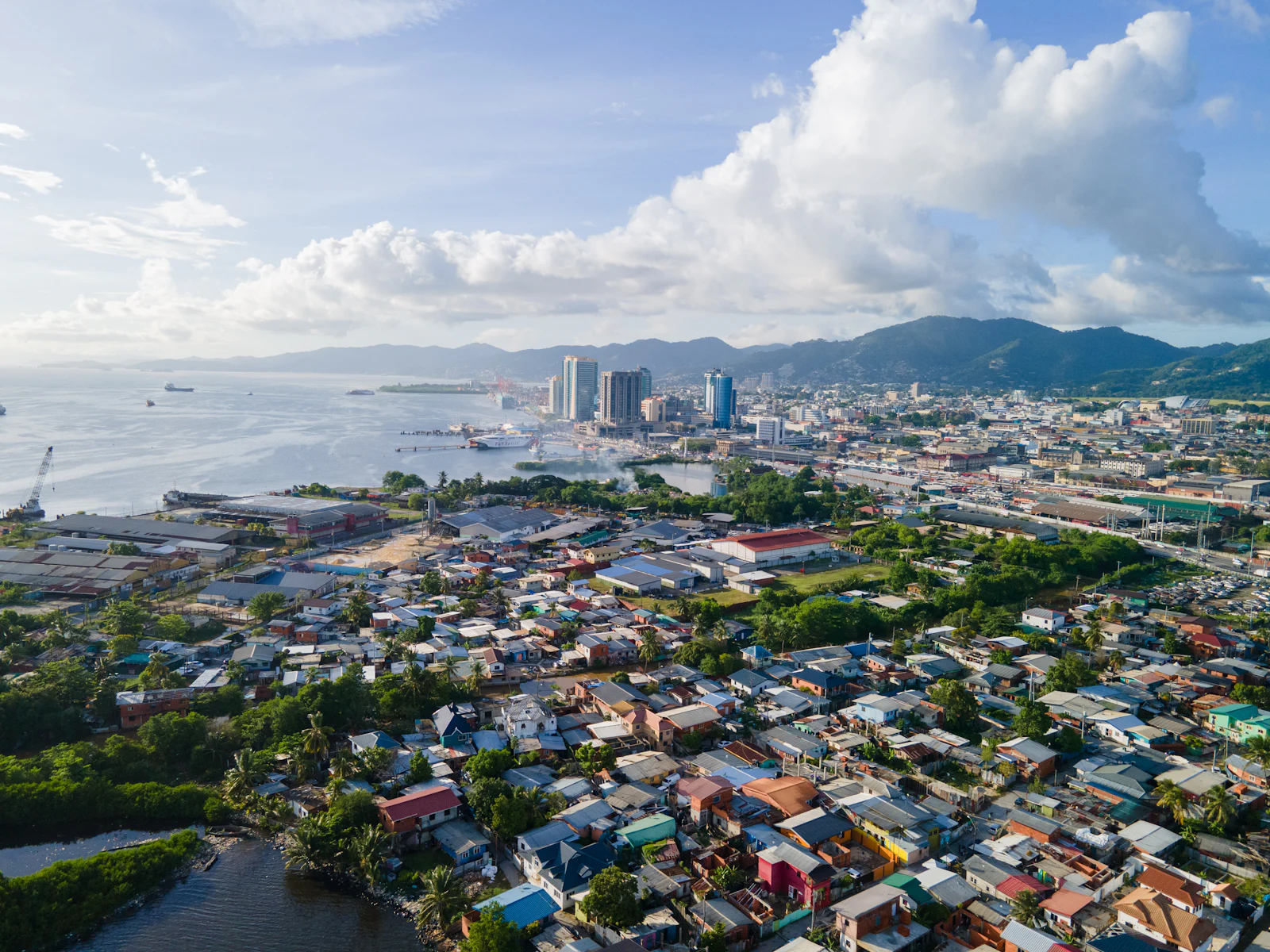 An aerial view of Port of Spain meeting the water.